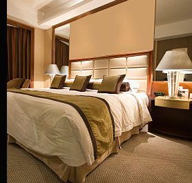 Bedroom Lighting with recessed low voltage halogen spot lights in the ceiling and large decorative bedside lamps