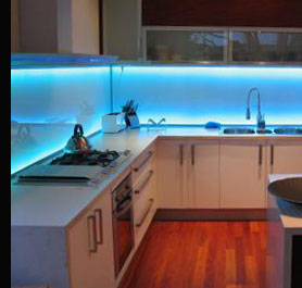 A Kitchen fitted with remote controled colour-changing LED under-unit strip lighting